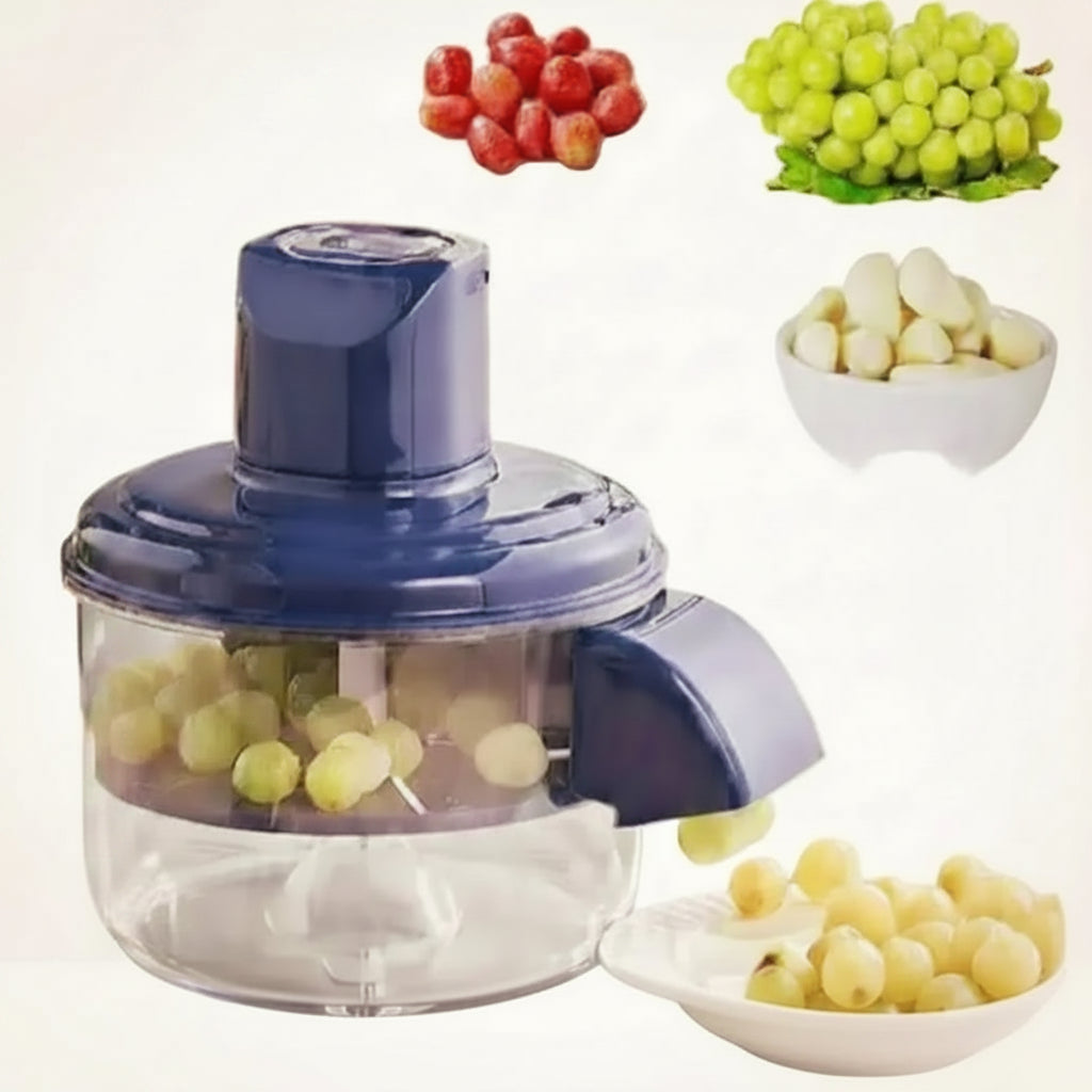 A small manual food Peeler with a dark blue lid and clear container, shown on a white background with fruit and vegetable examples including red strawberries, green grapes, garlic, and pale yellow bulbs. The text 'Peel Fresh' appears in the top left.
